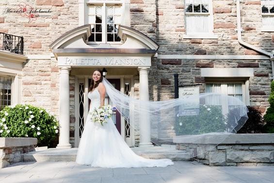 beautiful bride in front of the Paletta Mansion in Burlington